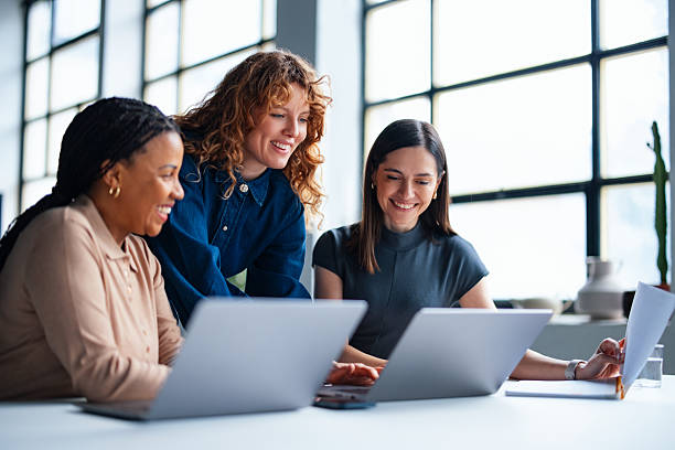 Deep Sync team members working together at a laptop